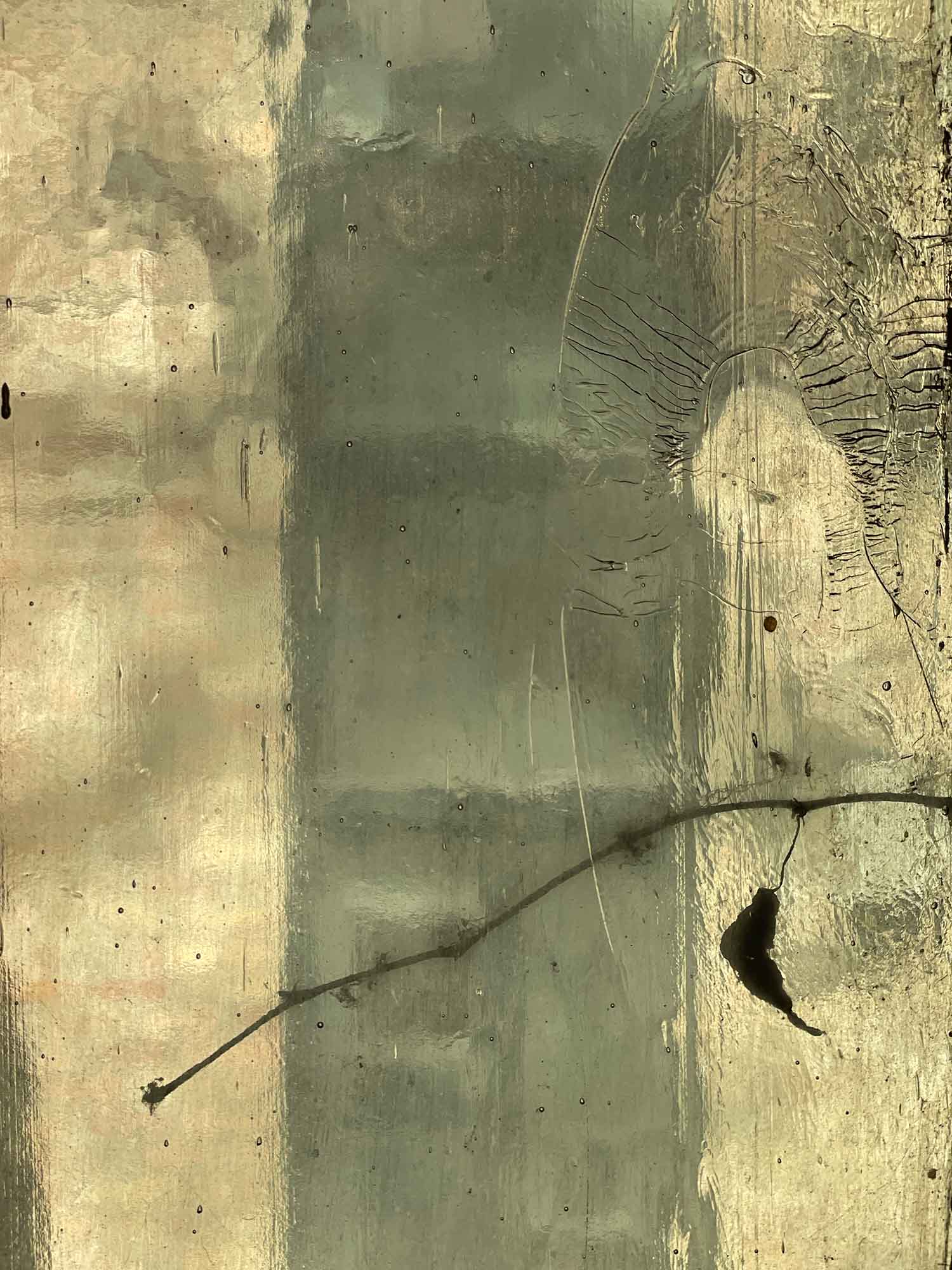 Detail of a yellow stained window pane with cracks